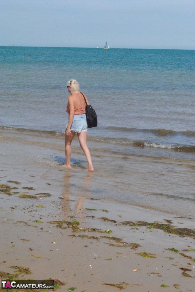 Older platinum blonde Dimonty takes a dip in the ocean  